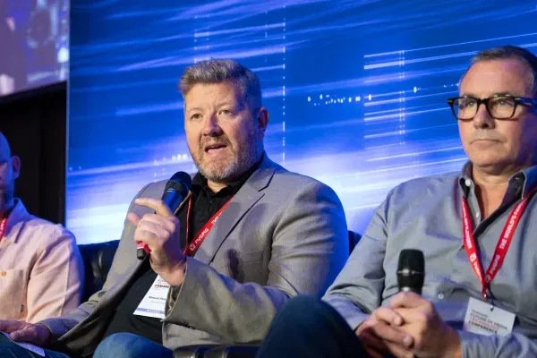 man speaking with mic on stage